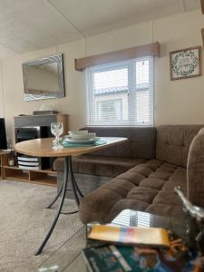 a living room with a couch and a table at Lovely 2-Bed Cabin in Birchington in Birchington
