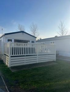 a white fence in front of a house at Lovely 2-Bed Cabin in Birchington in Birchington
