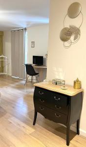 a living room with a dresser and a desk at Maison Bossoreil - Chambre Layon in Angers