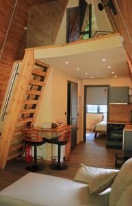 a kitchen and living room with a spiral staircase at Pavliani4rest - Luxury Cabins in Pávliani