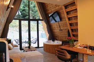 a living room with a tub and a table at Pavliani4rest - Luxury Cabins in Pavliani