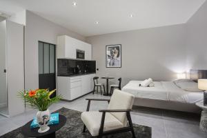 een slaapkamer met een bed en een woonkamer bij Residense Montmartre by Studio prestige in Parijs