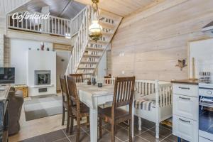 a kitchen and dining room with a table and chairs at Hallahaukka in Ivalo