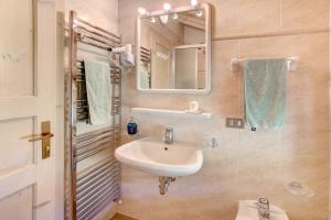 a bathroom with a sink and a mirror at Appartamenti Lorenza 3 Baite Giotto in Livigno