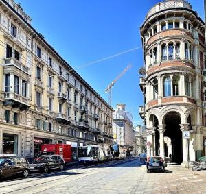 a city street with cars parked in front of buildings at Casa dell'Inno di Mameli in Turin