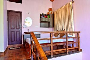 a room with a bed with a wooden railing at Hulihara Homestay - Full Villa, Coffee Estate & Balcony View in Sakleshpur