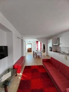 a living room with a red couch and a red rug at La Casa sul lago in Fara San Martino