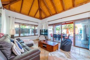 a living room with a couch and a tv at Villa Loira in Corralejo
