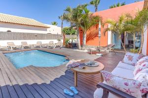 a patio with a pool and a table and chairs at Villa Loira in Corralejo