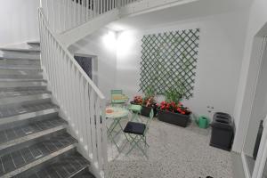 a stairway with a table and chairs and a plant at Zuara9Room Rimini in Rimini