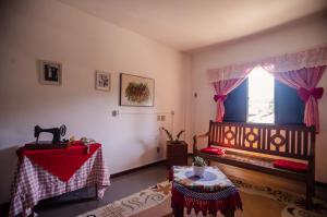 a living room with a table and a window at Alpes Hotel in Venda Nova do Imigrante +37 photos
