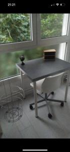 a desk with a chair in front of a window at se: 13A rue des Touleuses Pourpre in Cergy