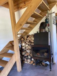 a room with a fireplace and a wooden stairs at Bajkowy Domek nad rzeką Liwiec in Łochów