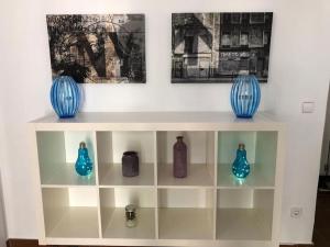 Trois vases bleus sont assis sur une étagère dans l'établissement Bonito apartamento en Calle San Carlos, à Madrid