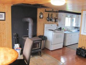 a kitchen with a stove and a table in it at Wolf Cove Retreat House in Amherst Cove