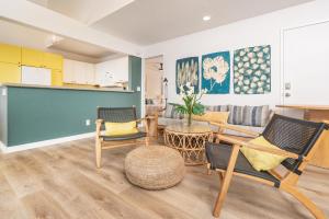 a living room with chairs and a couch at Pali Ke Kua #204 in Princeville