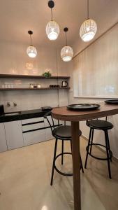a kitchen with a table and two chairs and lights at Boho Studio in Pune