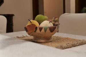 a bowl of fruit sitting on a table at AnyfApartment Kalamata in Kalamata