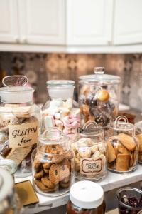 a table with many jars of different types of pastries at La Piazzetta Rooms & Apartments in Genova