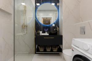 a bathroom with a mirror and a sink and a toilet at Ursus Nova Apartment with Parking by Renters Prestige in Warsaw