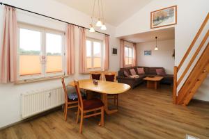 a living room with a table and a couch at Ferienwohnung Ostseecharme Rei in Ostseebad Karlshagen