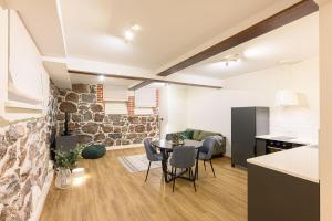 a kitchen and living room with a table and chairs at Grand Hotel Residents in Tartu