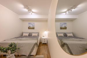 a room with two beds and a mirror at Grand Hotel Residents in Tartu
