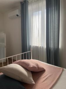 1 dormitorio con 1 cama y una ventana con cortinas en Maison Bon Ton, en Villafranca dʼAsti