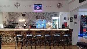 a bar with a bunch of stools in a room at Triple Twenty in Eschweiler