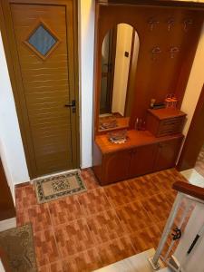 a bathroom with a sink and a mirror next to a door at Guesthouse Space in Përmet