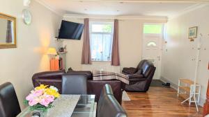 a living room with two couches and a table at New Holiday Let in Skipton, North Yorkshire in Skipton