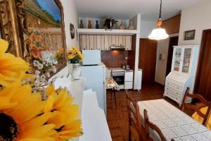 a kitchen with a table with a sunflower on it at Il Quadrifoglio Bilocale tra Lavagna e Chiavari in Carasco
