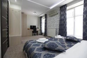 a bedroom with a bed with a blue comforter at City Code Exclusive in Belgrade