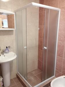 a shower with a glass door in a bathroom at Apartments Vidikovac in Tivat