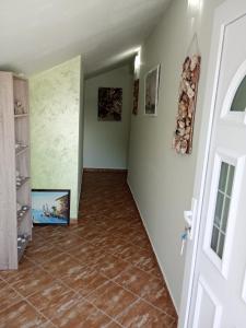 a hallway with a tile floor and a door at Apartments Vidikovac in Tivat