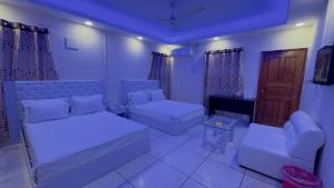 a living room with two beds and a couch at Hotel Blue Sky Inn Banani in Dhaka