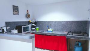 a kitchen with a counter top with a red towel at YZRAJ Homestay in El Nido