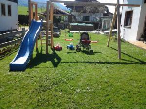 a playground with a slide and a wheelchair in a yard at Ferienwohnung Enzinger in Teisendorf