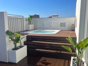 a hot tub on top of a balcony with plants at WeLive Trapani - luxury apartments in Trapani