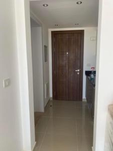 a hallway with a wooden door in a house at Studio EL Gouna G-Cribs in Hurghada