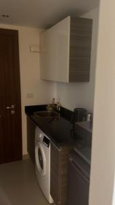 a kitchen with a sink and a washing machine at Studio EL Gouna G-Cribs in Hurghada