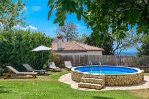 a pool in a yard with a bench and an umbrella at Apartment in Barban/Istrien 8297 in Barban