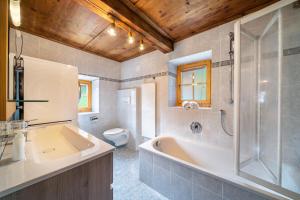 a bathroom with a tub and a toilet and a sink at Ferienhaus Engele in San Martino +23 photos