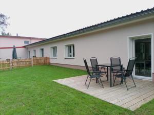 a patio with chairs and a table in a yard at Falkenhof Meisdorf in Meisdorf