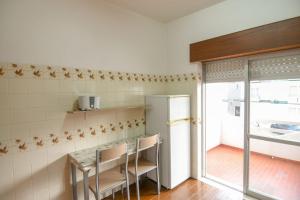 a kitchen with a table and a refrigerator at EastView Lagos in Lagos +13 photos