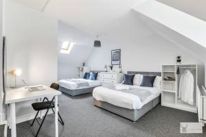 a white room with a bed and a table and a desk at Silver Stag Properties, 4 BR Gem in Coalville in Coalville