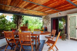 an outdoor dining room with a wooden table and chairs at Dolce Vita in La Ciotat