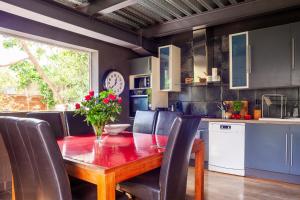 a kitchen with a wooden table and chairs at Dolce Vita - Jacuzzi - La Ciotat in Virebelle +27 photos