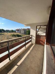 a balcony of a house with a wooden door at Mountain Paradise 1 - 1 Bright Two Floor Apartment - wifi -balcony in Bansko