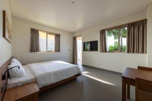 Postel nebo postele na pokoji v ubytování Cát Vàng Hotel & Apartment